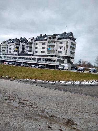 a large building with cars parked in front of it at apartament in Rzeszów