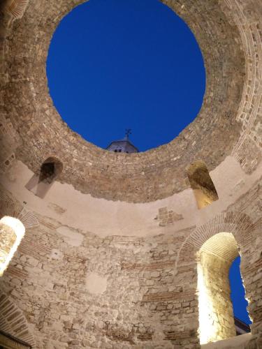an archway in a tower with a cross in the sky at Apartment Altitudo Split sea and city view terrace comfortable and new in Split