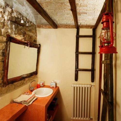 a bathroom with a sink and a mirror at I Veroni - Agriturismo and Wine Cellar in Pontassieve