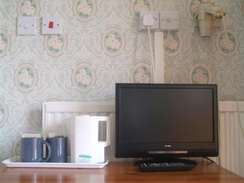 a computer monitor sitting on top of a desk at Royal Hotel in Blackpool