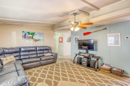 a living room with a couch and a flat screen tv at Sandy Toes in Mexico Beach