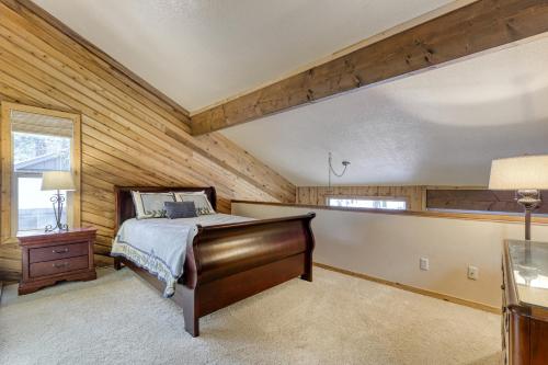 a bedroom with a bed in a room with wooden walls at 2 Conifer in Sunriver