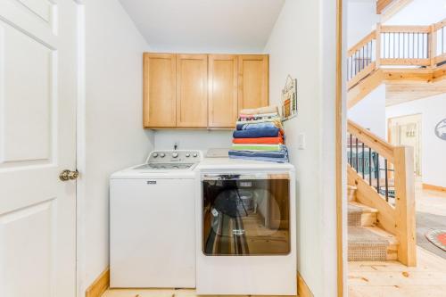 a kitchen with a washing machine and a staircase at 22 Quelah in Sunriver