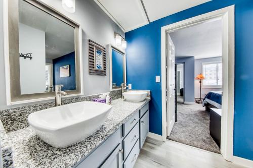 a bathroom with two sinks and a large mirror at Timberbrook #215A in Brian Head