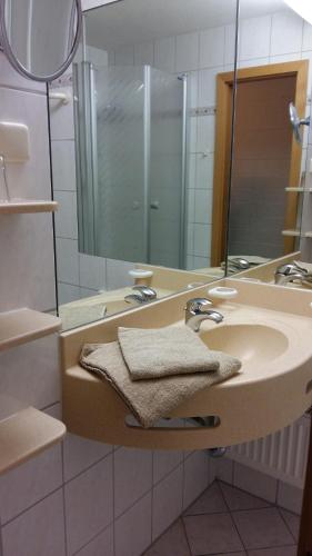 a bathroom with a sink and a mirror at Herzerl Apartment in Sankt Englmar