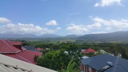 a view of a town with mountains in the background at SaS NEMO in Lamentin