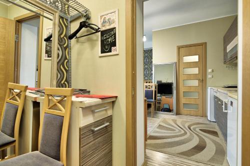 a kitchen with a counter and a dining room at Quiet Romantic Studio plus parking, Tartu Home in Tartu