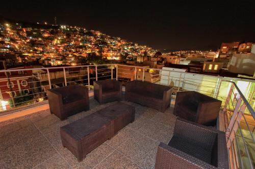 a balcony with two chairs and a couch on a building at Hotel Real Guanajuato in Guanajuato