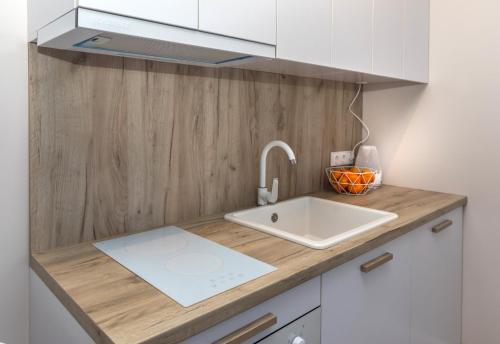 a kitchen with a sink and a counter top at Relax apartments near Egle in Druskininkai