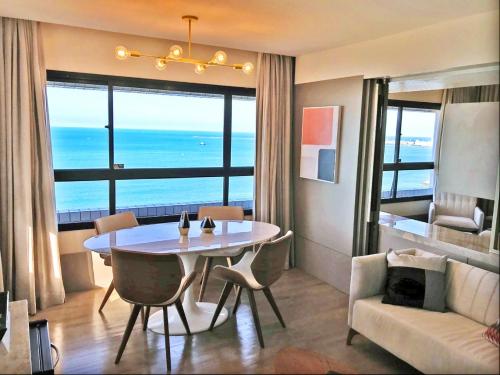 a living room with a table and a couch at Bourbon Fortaleza Hotel Beira Mar in Fortaleza