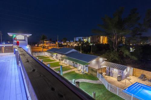 a view of a building with a pool at night at Lost Inn Paradise in Cocoa Beach