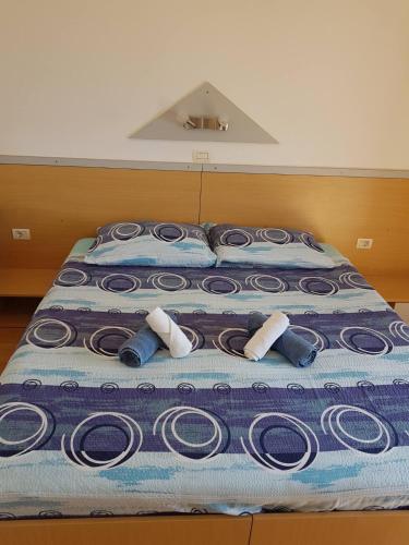 a bed with a bunch of swirls on it at Apartments & Rooms Villa Adamović in Umag