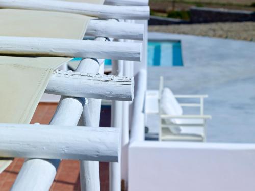 a white railing next to a swimming pool at Villa Gallis in Pollonia