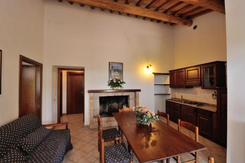 a living room with a table and a fireplace at Agriturismo Belsito Pian Di Boccio in Bevagna
