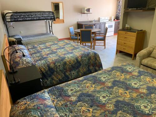 a hotel room with two beds and a kitchen at Gateway Motel in Minnedosa