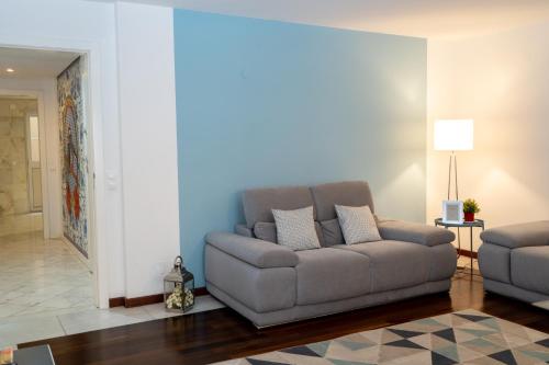 a living room with a couch and a table at Chiado Patio Apartment in Lisbon