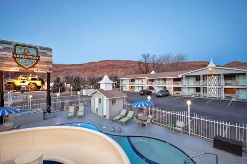 a resort with a swimming pool and a parking lot at Expedition Lodge Moab Arches National Park in Moab