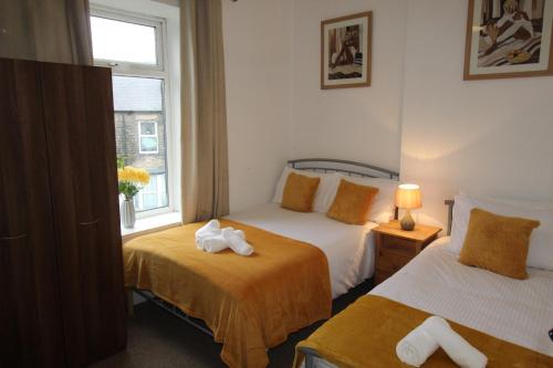 a hotel room with two beds and a window at Stafford House in Sheffield