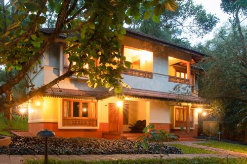 a house with lights on the side of it at Greenwoods Resort, Thekkady in Thekkady