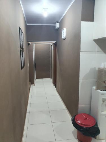 a small bathroom with a toilet and a hallway at Pousada Pimenta Olimpia in Olímpia