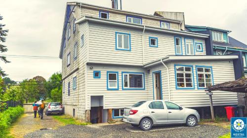 a house with a car parked in front of it at Hostal Compass del Sur in Puerto Varas