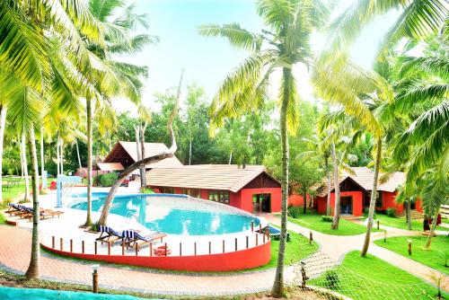 a resort with a swimming pool and palm trees at GoGo Land Resort & Adventurous Sports in Pūvār