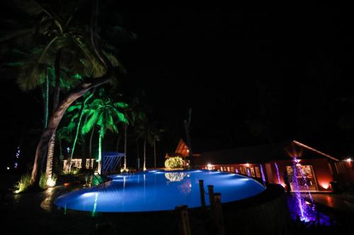 a swimming pool at night with lights at GoGo Land Resort & Adventurous Sports in Pūvār