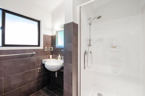 a bathroom with a toilet sink and a shower at The Rivers - Kuratau Holiday Home in Kuratau
