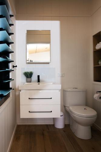 a bathroom with a white sink and a toilet at Reflections Moonee Beach - Holiday Park in Moonee Beach