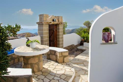 a stone patio with a table and a fireplace at Drougas' Windmill in Plaka Milou