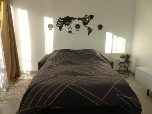 a bed in a bedroom with a world map on the wall at LE 31 in Cannes
