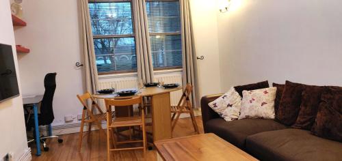 a living room with a couch and a table at The Hideaway in London in London