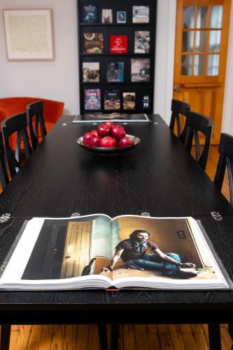 an open book on a table with a plate of apples at Seven Resort Style Inn near Beach in Shelter Island Heights