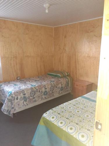 Postel nebo postele na pokoji v ubytování Cabaña Emilia Quinchen