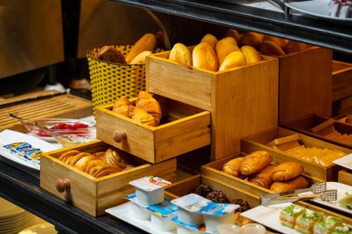 a bakery with wooden boxes filled with breads and pastries at Shining Central Hotel & Spa in Hanoi