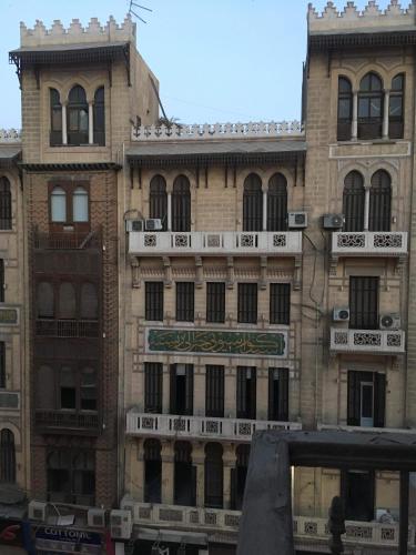 a large brick building with a sign on it at Berlin Hotel in Cairo