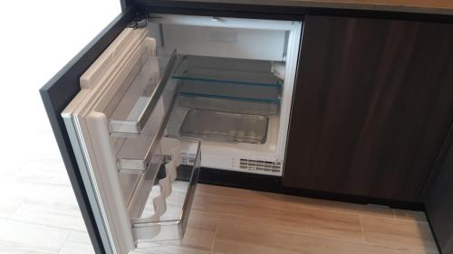 an empty refrigerator with its door open in a kitchen at CEBU APPARTMENT in Hong Kong