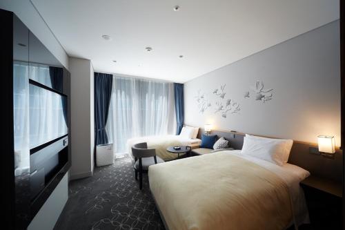 Ένα ή περισσότερα κρεβάτια σε δωμάτιο στο Hotel Gracery Seoul