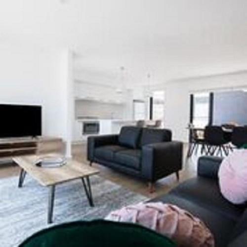 a living room with a couch and a table at Timor Street Apartments in Warrnambool