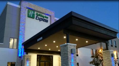 a building with a sign on the side of it at Holiday Inn Express & Suites - Oklahoma City Airport by IHG in Oklahoma City