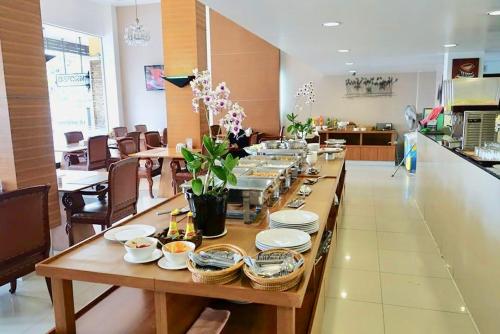 a long table with plates and bowls on top of it at Paholyothin Park Place in Bangkok