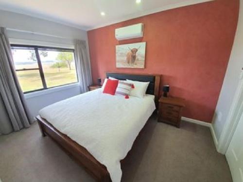a bedroom with a large bed and a window at Pleasant Hill BnB in Mount Gambier