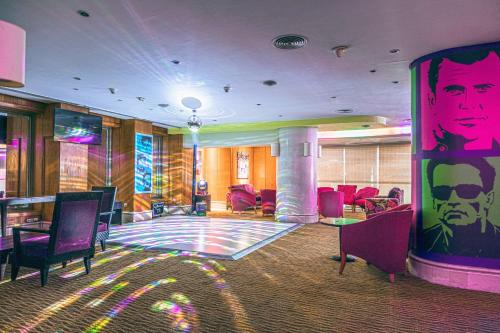 a lobby with chairs and a painting of a man at Holiday Inn Citystars, an IHG Hotel in Cairo