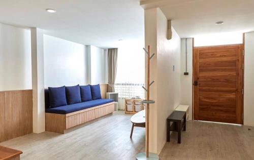 a living room with a blue couch in a room at Vann House Hua Hin in Hua Hin