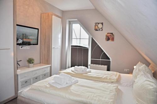 a bedroom with two beds and a staircase at Bellevue 12 in Laboe