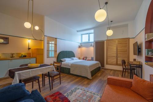a bedroom with a bed and a living room at CozyBaity in the very heart of Tbilisi in Tbilisi City