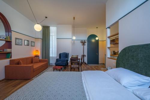 a bedroom with a bed and a living room at Cozy Baity Tbilisi in Tbilisi City