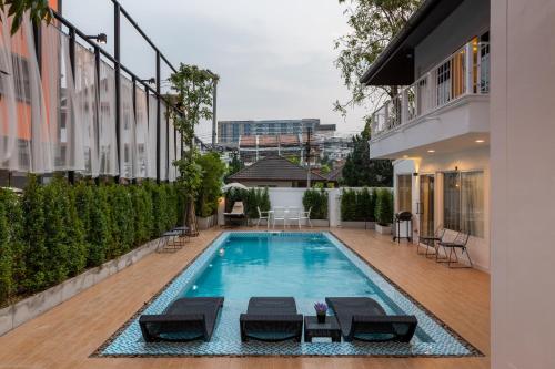 a swimming pool in the middle of a building at Nimman Villa 17 Chiangmai - SHA PLUS in Chiang Mai