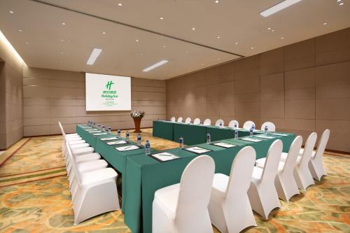 a conference room with a green table and white chairs at Holiday Inn Shanghai Hongqiao Central by IHG in Shanghai