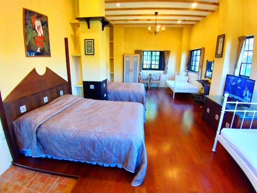 a bedroom with two beds and a living room at 南投清境挪威森林 in Renai